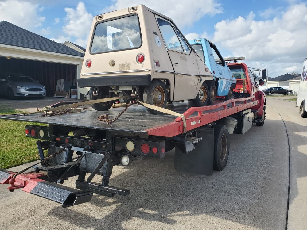 Utility vehicle secured on a flatbed truck - AA Affordable Towing