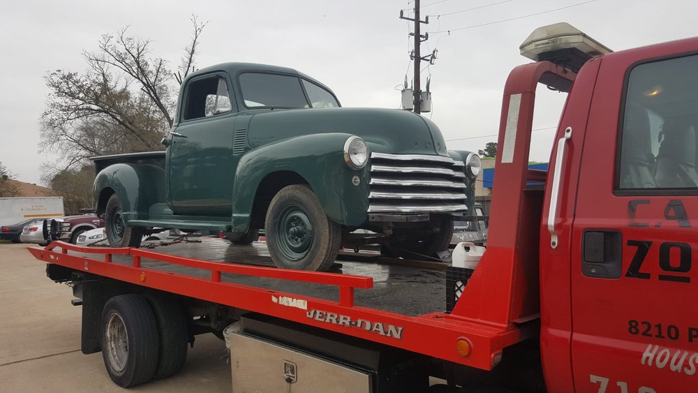 Vintage pickup truck transported on a red flatbed - AA Affordable Towing