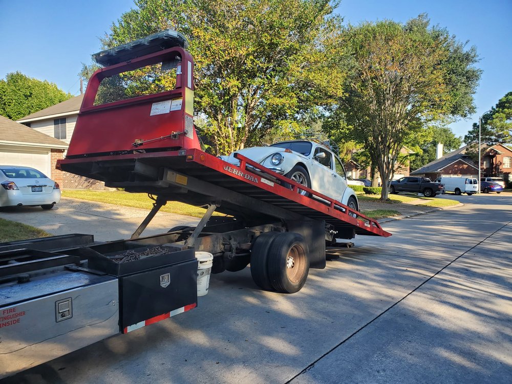 Tow truck with its flatbed tilted for loading - AA Affordable Towing